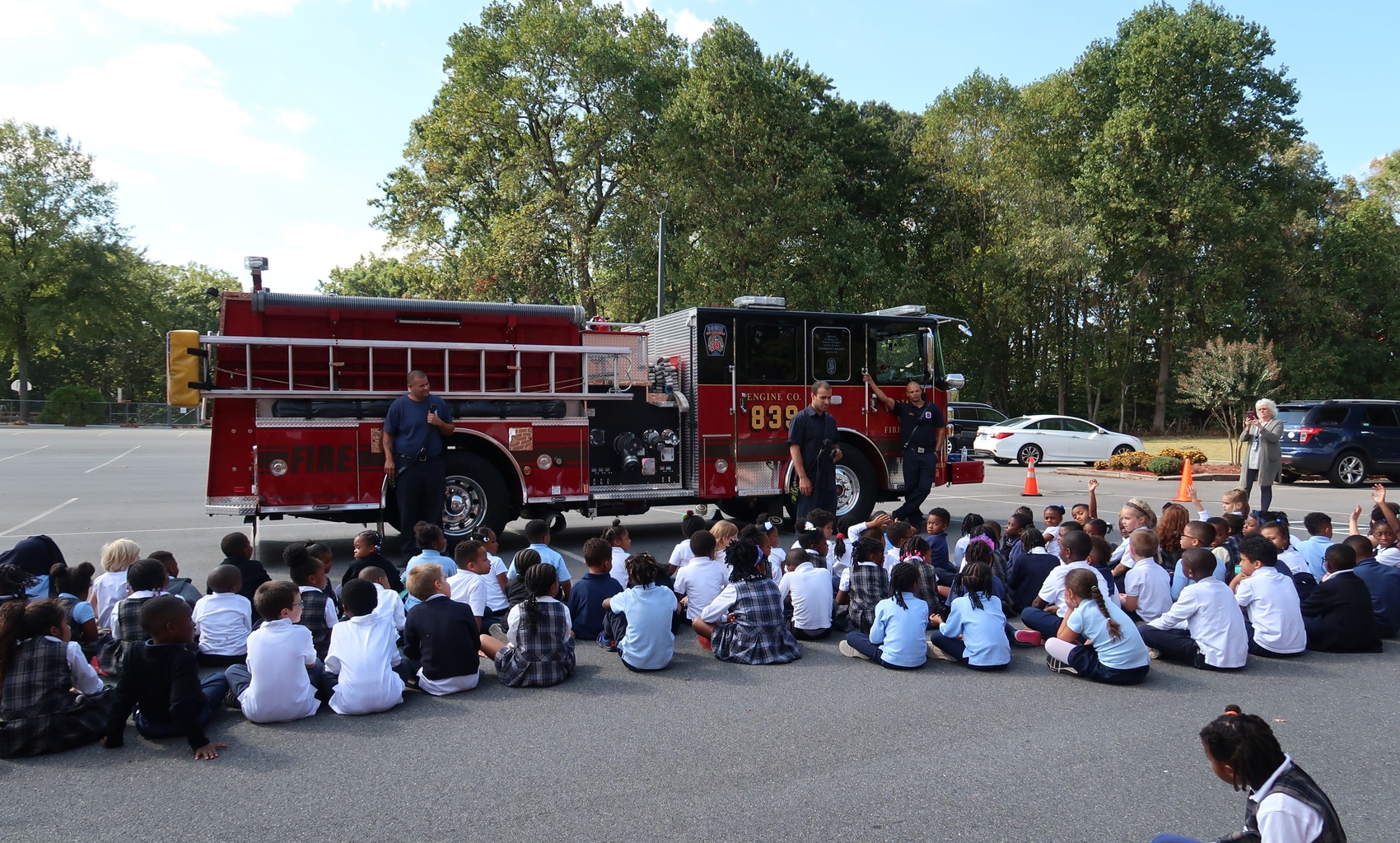 children learning by a firetruck